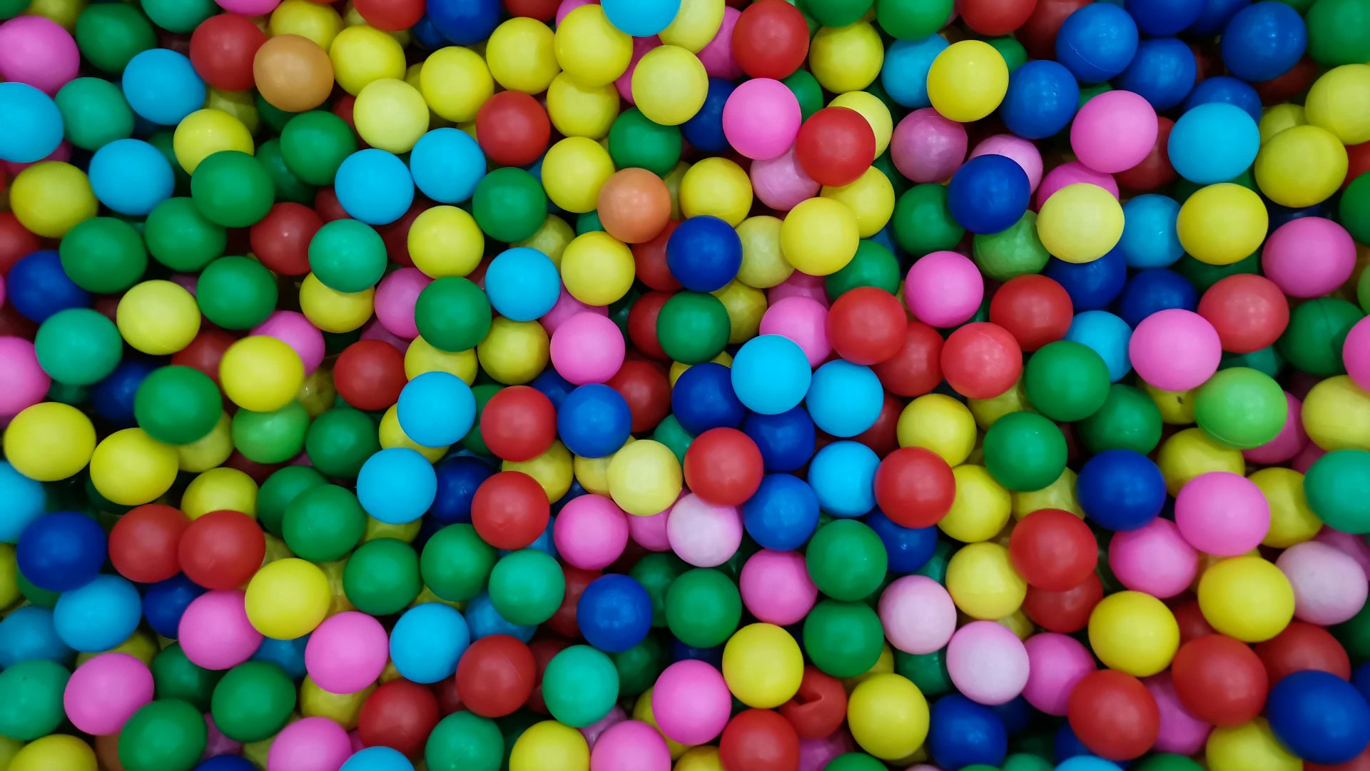 a bunch of colorful balls in a pile