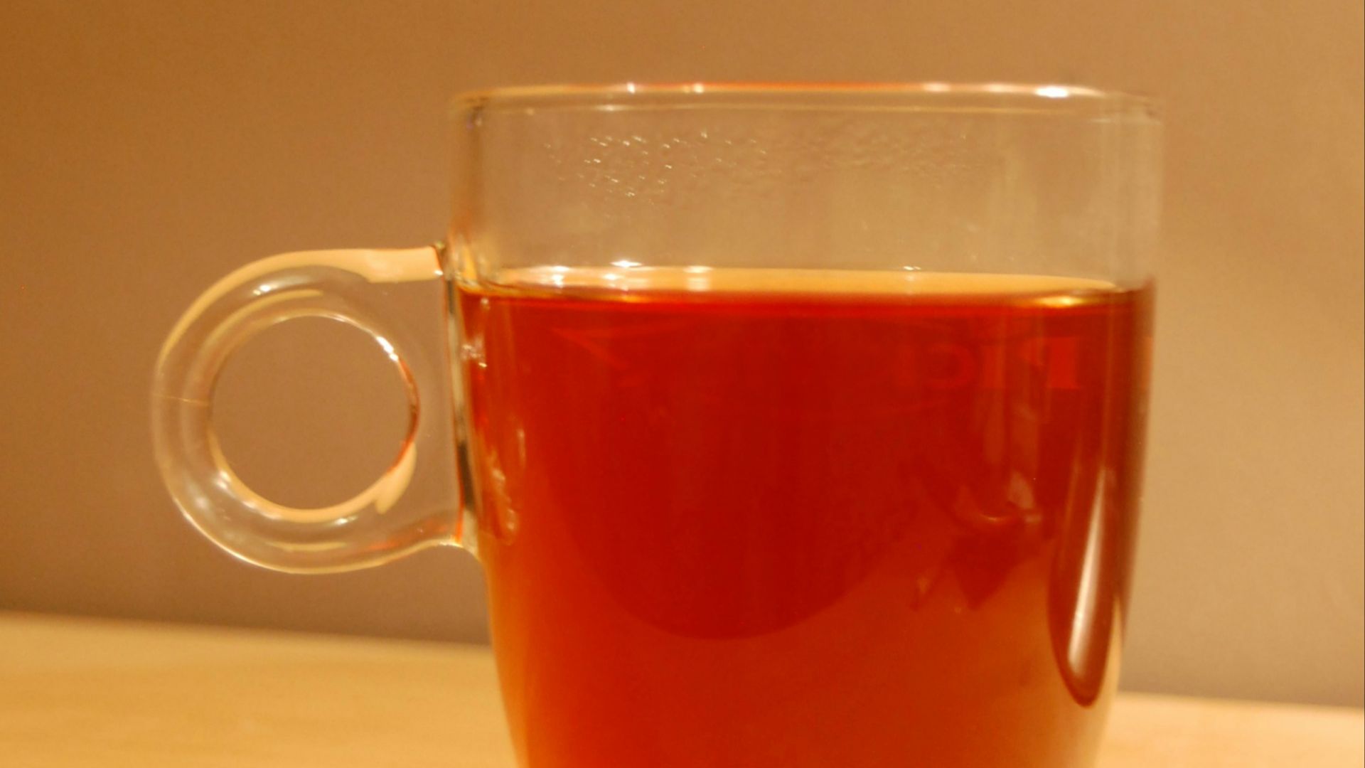 clear glass mug with brown liquid