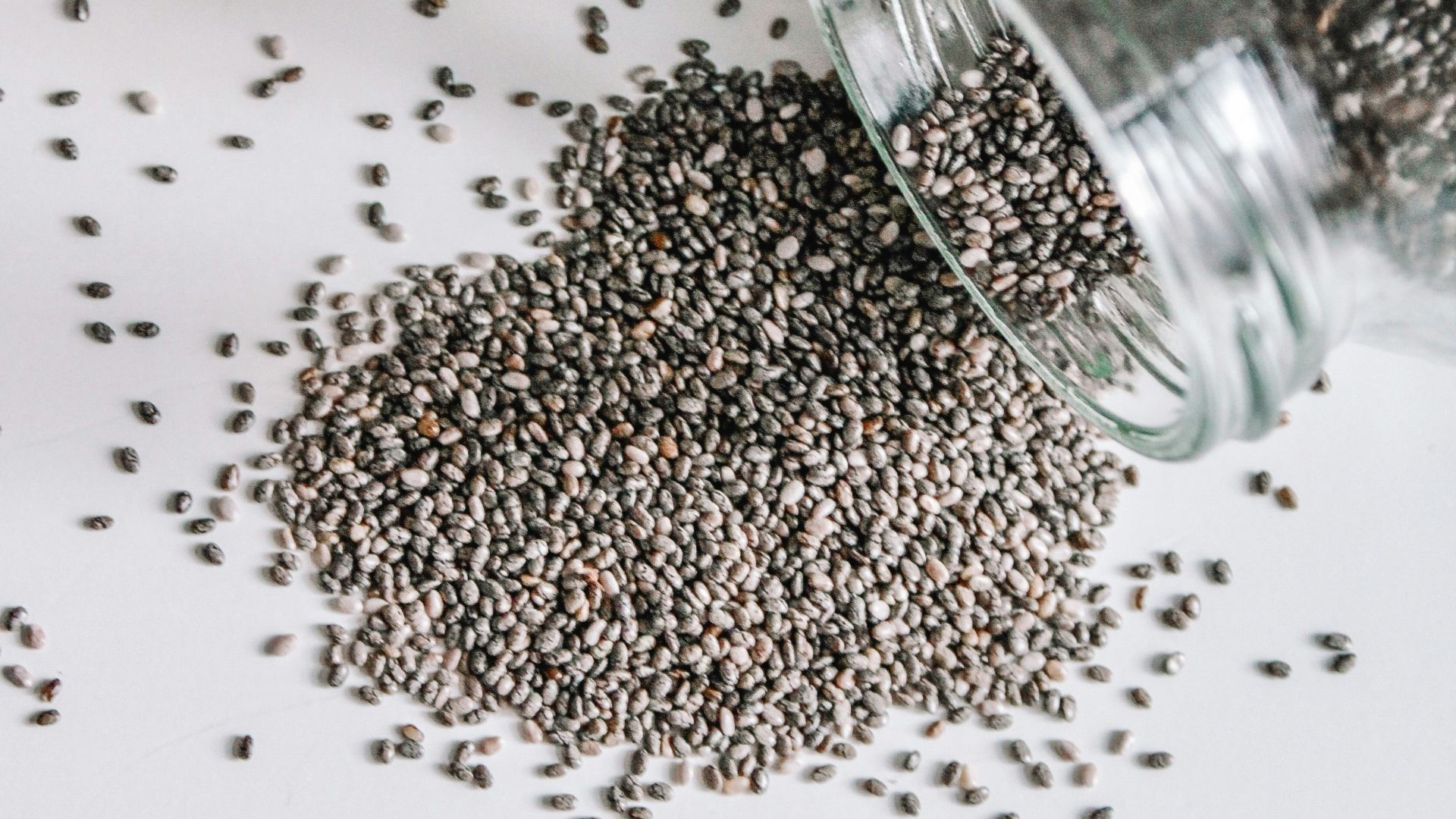 black beads in clear glass jar
