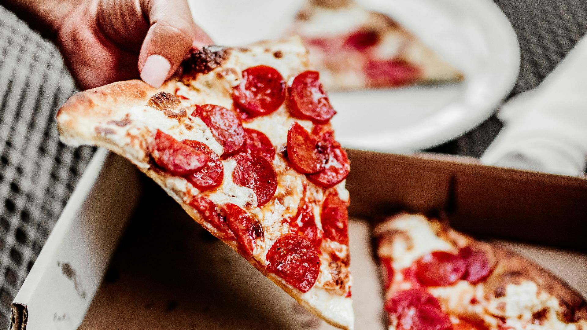 sliced pizza on white ceramic plate