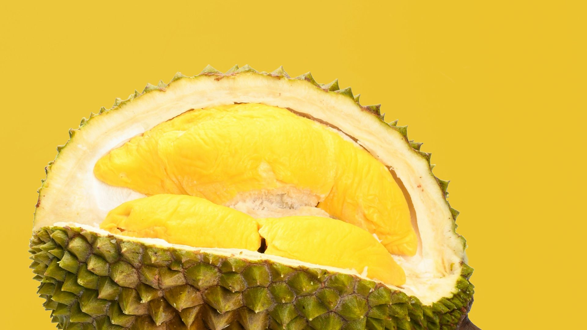 green and yellow fruit with brown stick