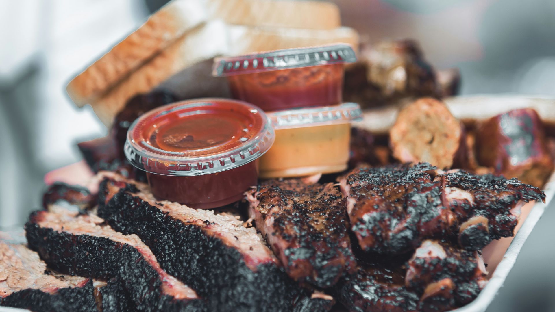 brown and white plastic container on black and brown chocolate cake