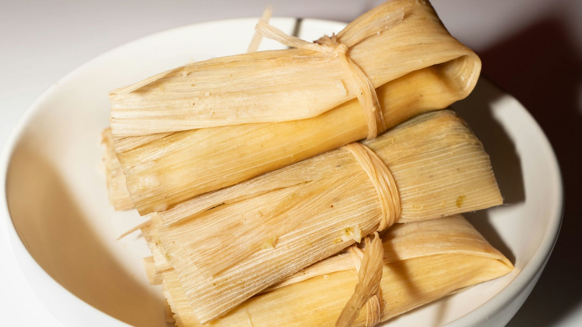 A white bowl filled with food on top of a table