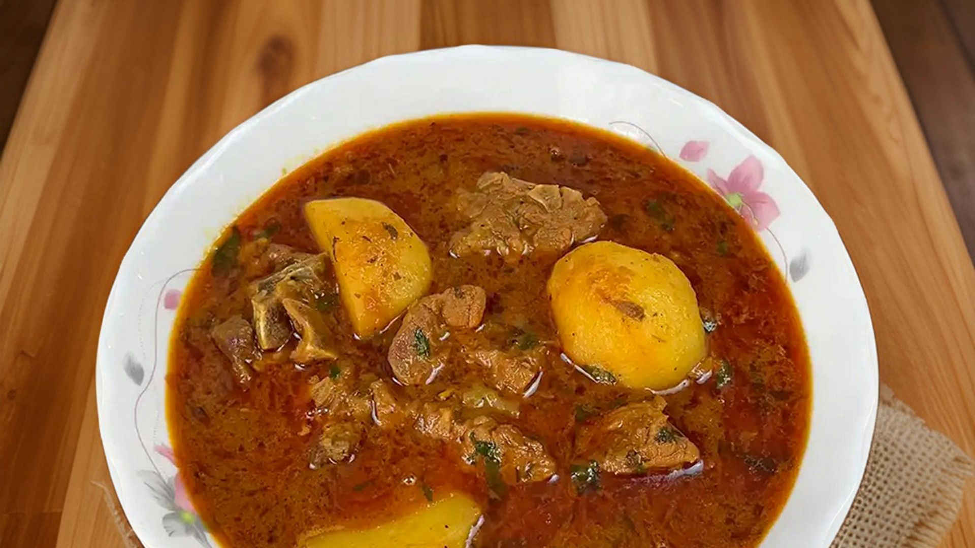 a bowl of stew on a wooden table