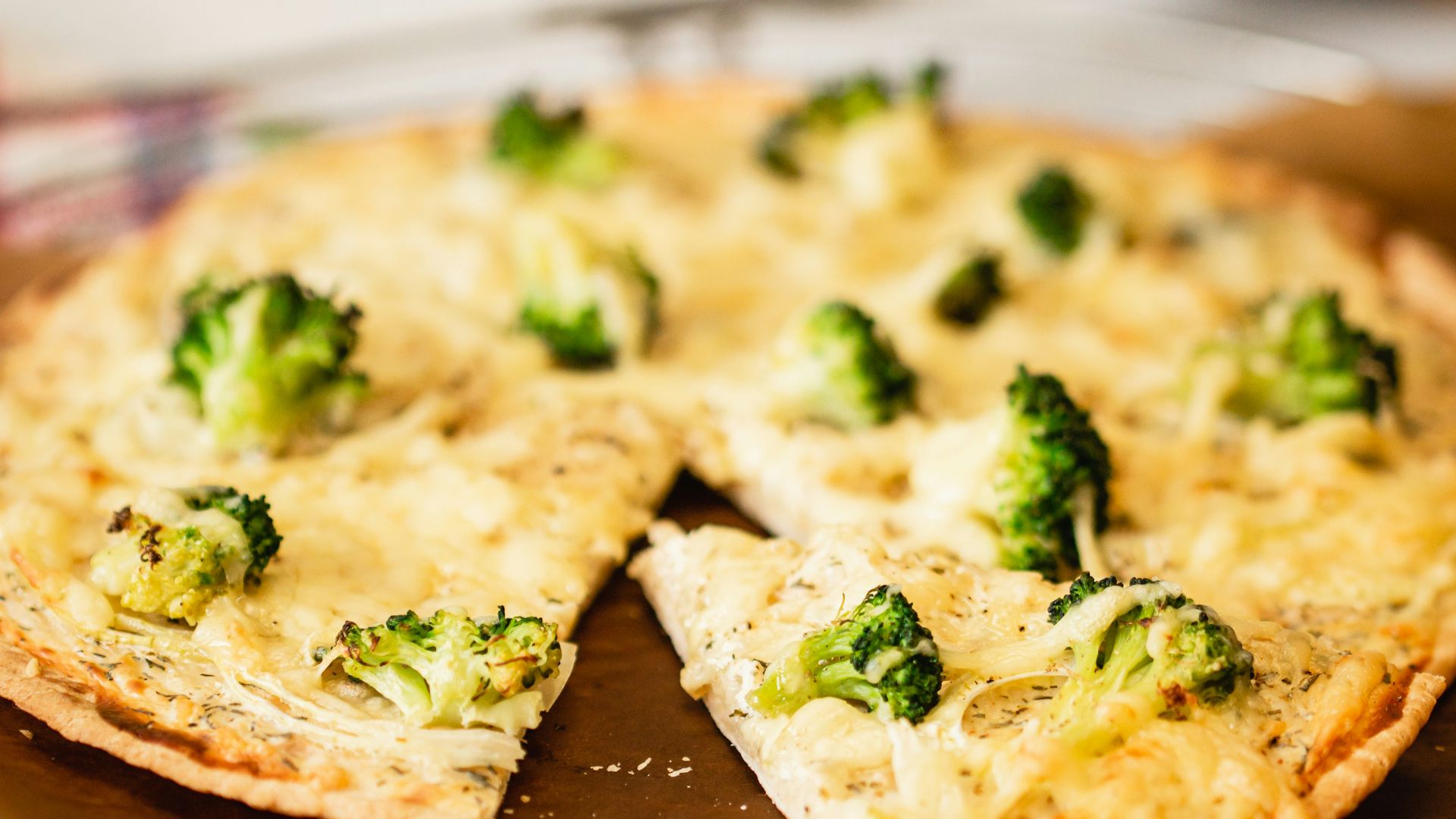brown and white pizza on brown wooden table