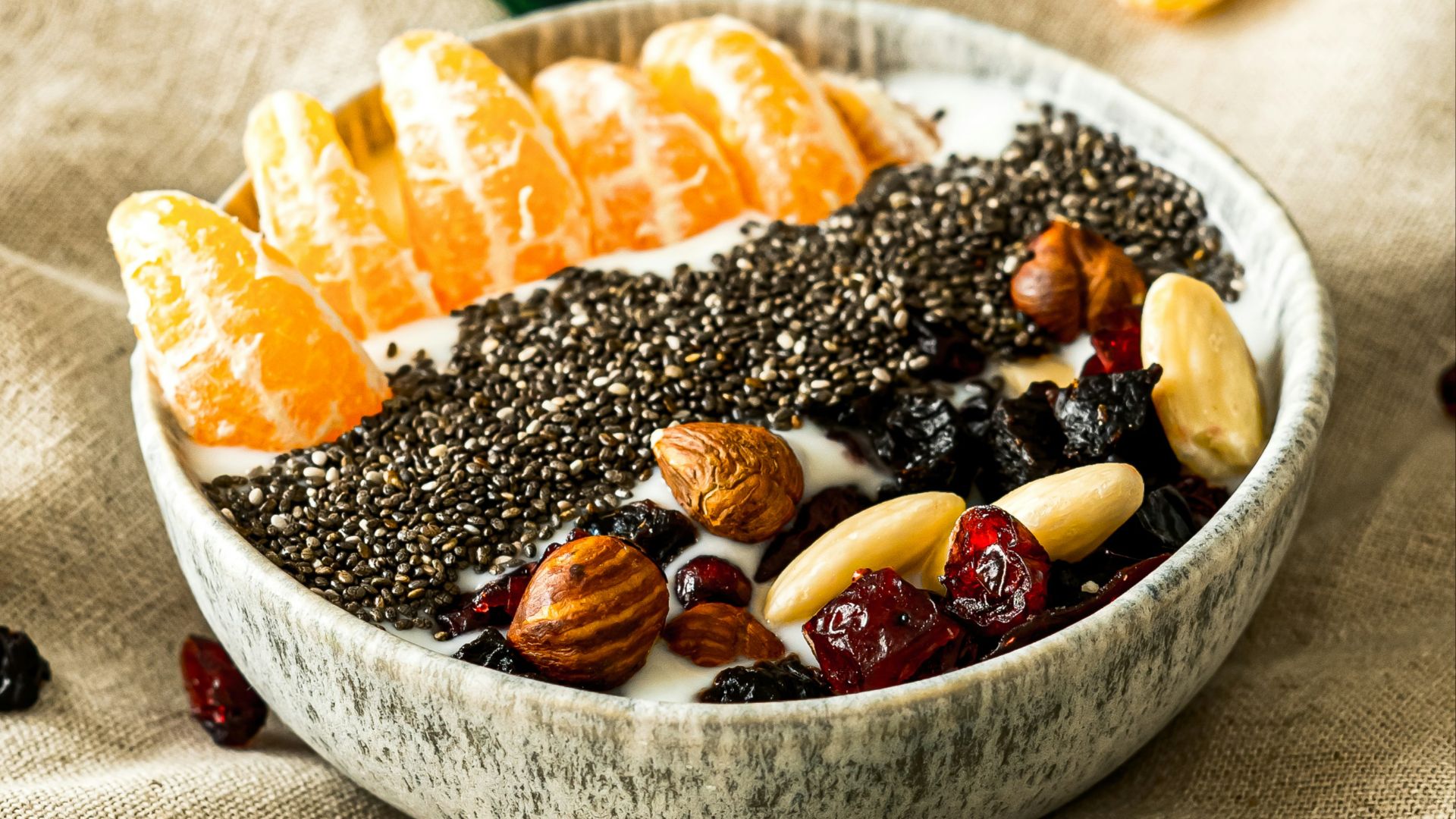 a bowl filled with fruit and nuts on top of a table