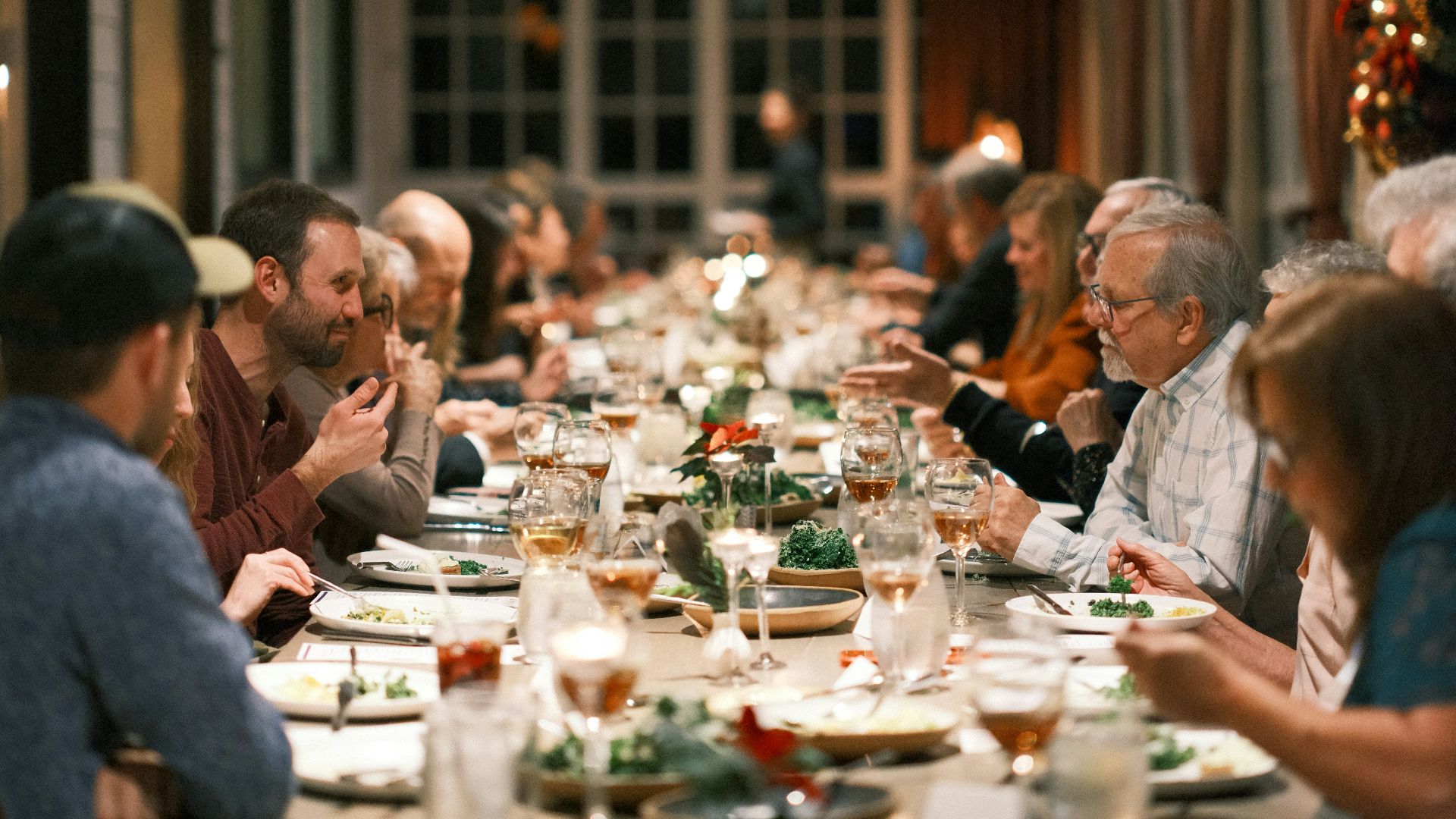a group of people sitting at a long table