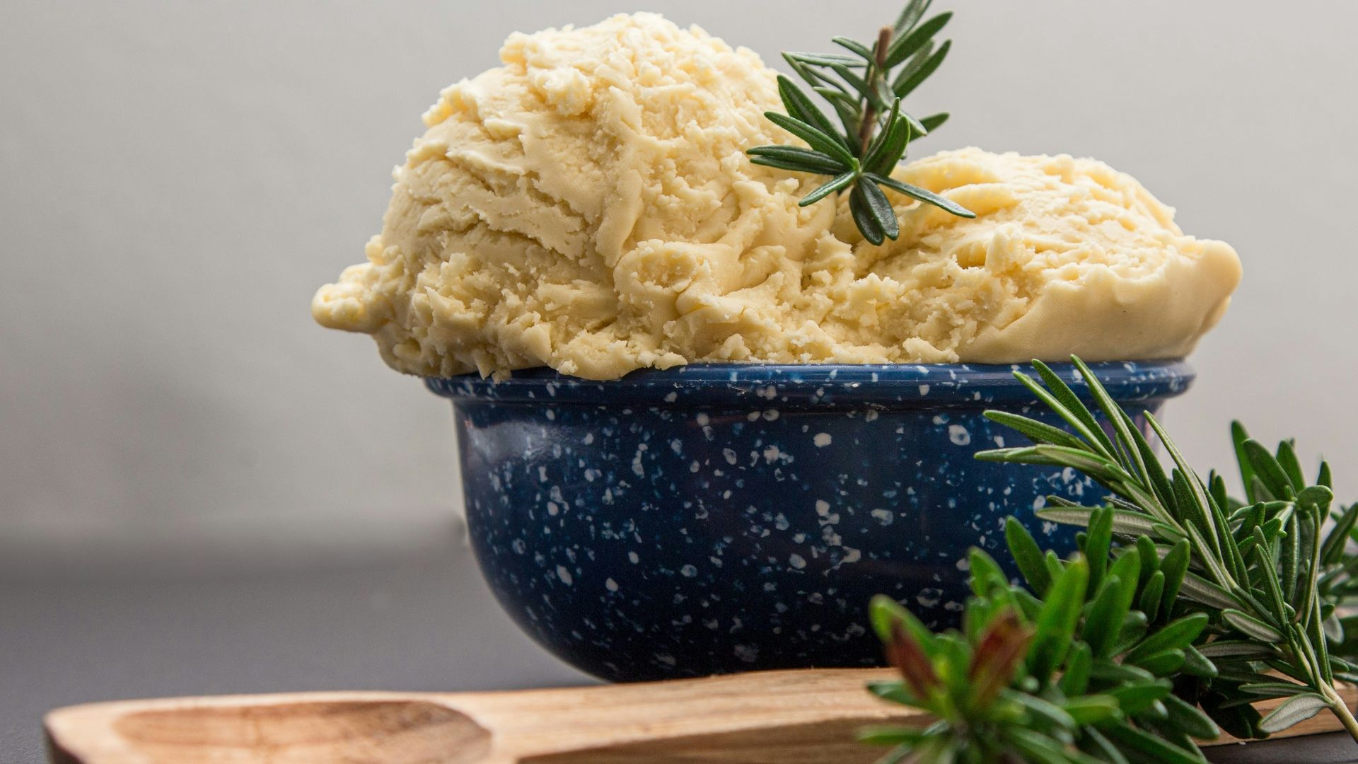 brown wooden spoon on blue ceramic bowl
