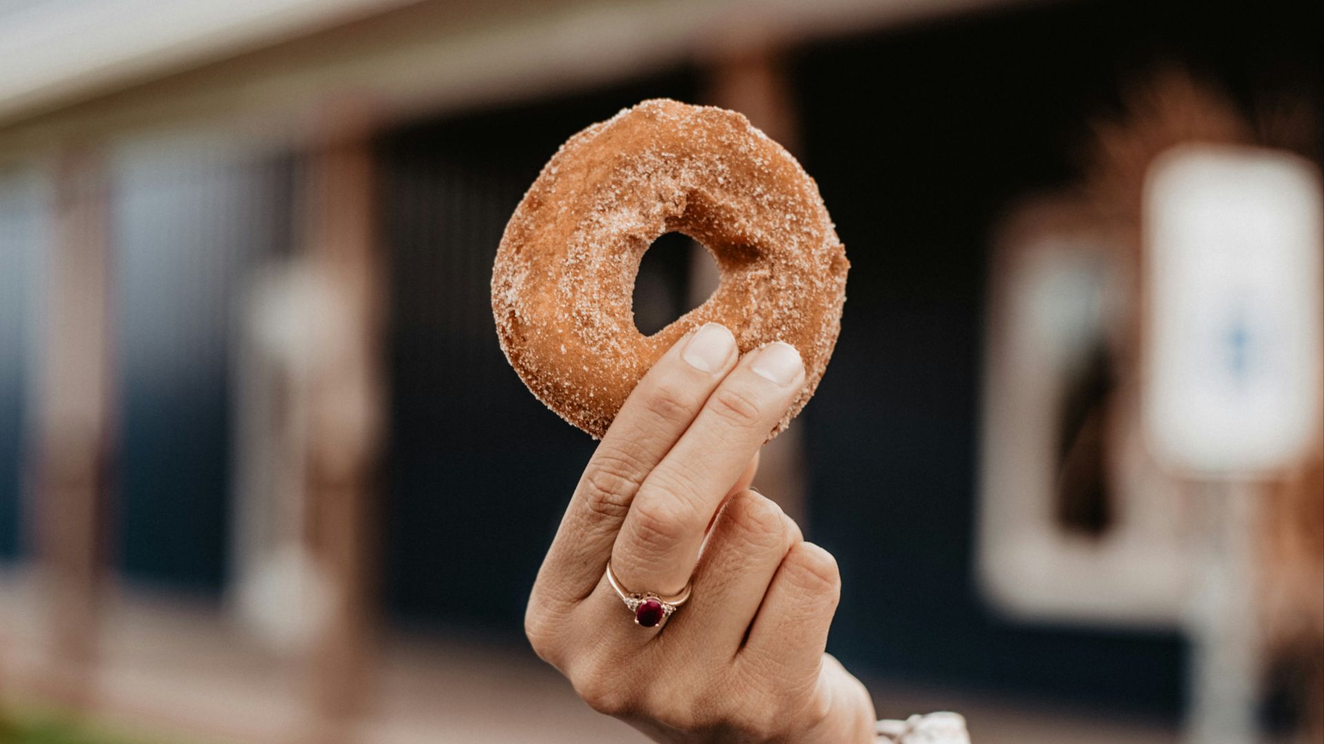 person holding doughnut during daytime