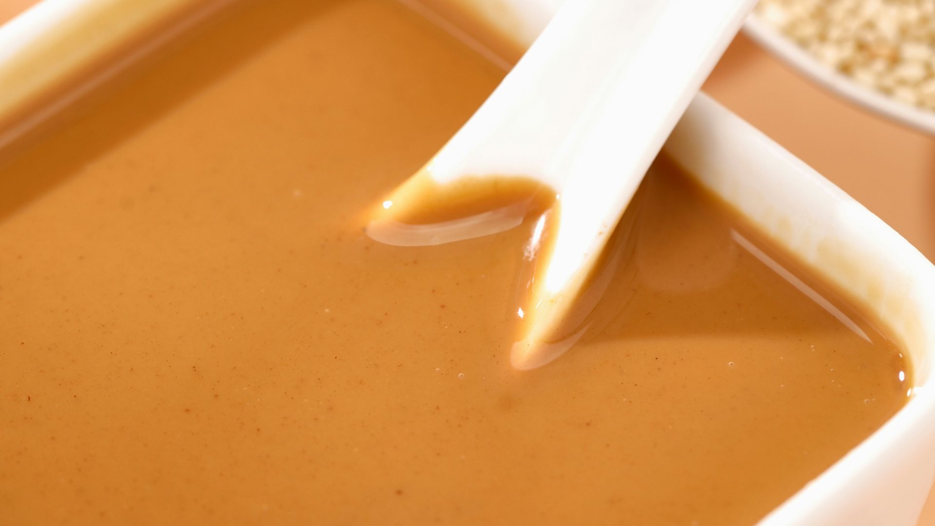 a bowl of soup with a spoon sticking out of it