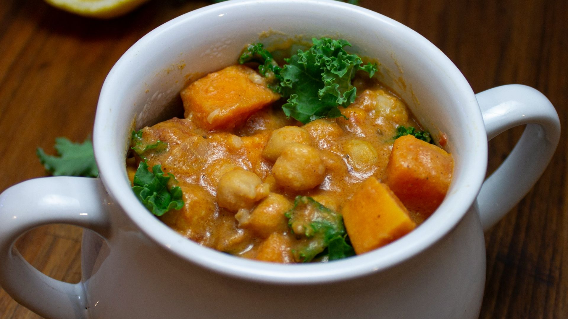 a bowl of food on a table next to a lemon