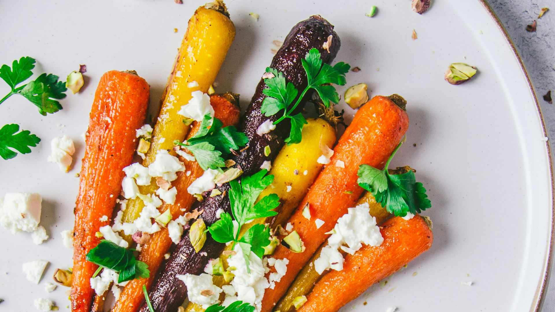 a white plate topped with carrots and feta cheese