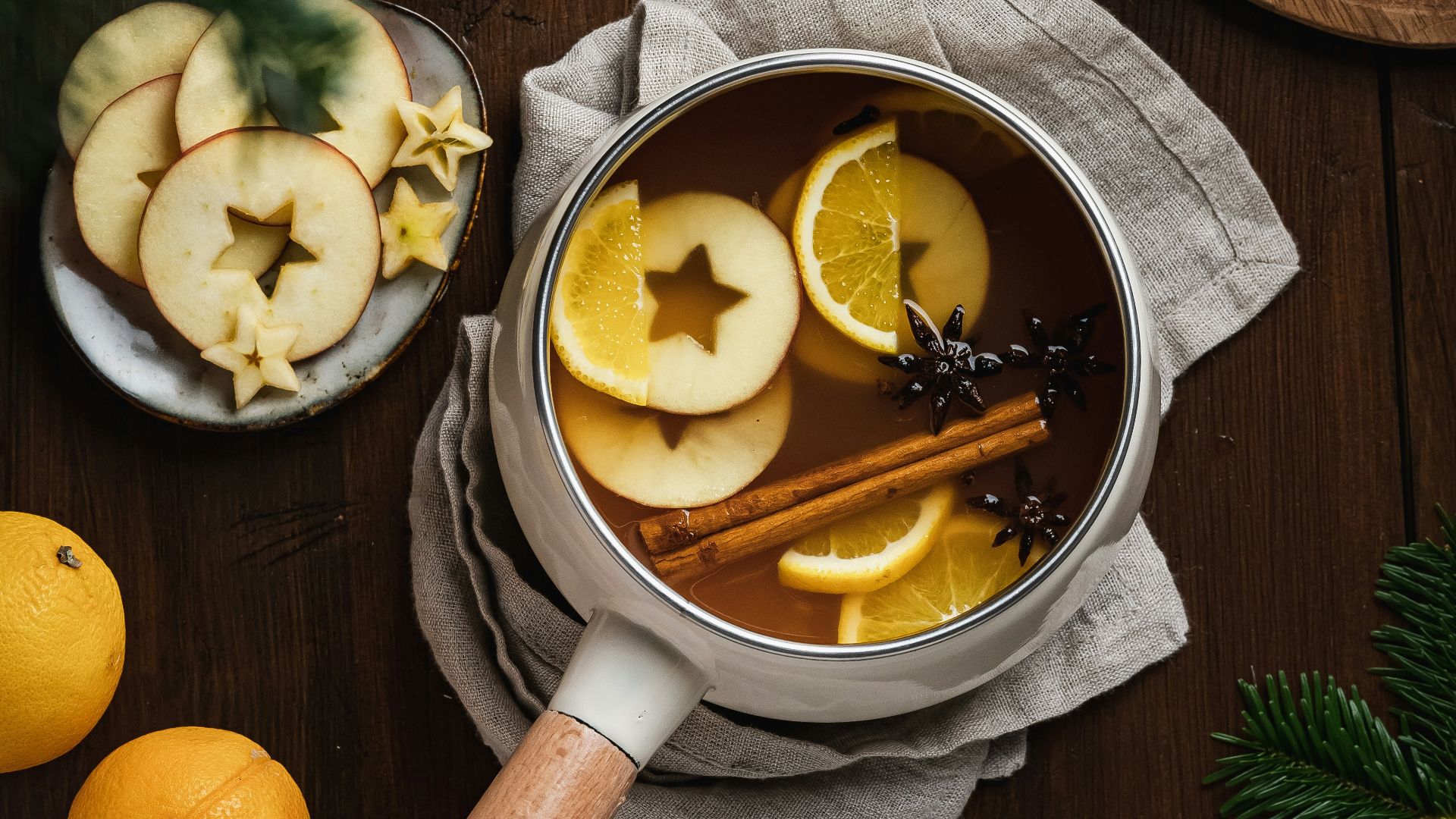 a wooden spoon with lemons and a bowl of sliced lemons