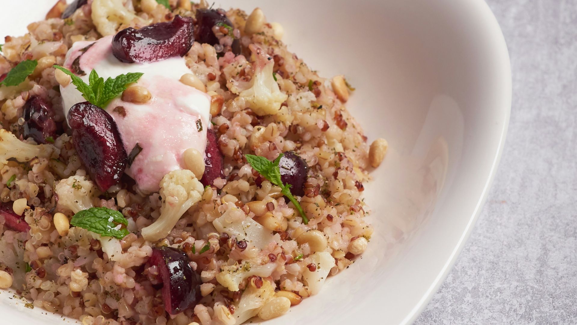 a white bowl filled with food on top of a table