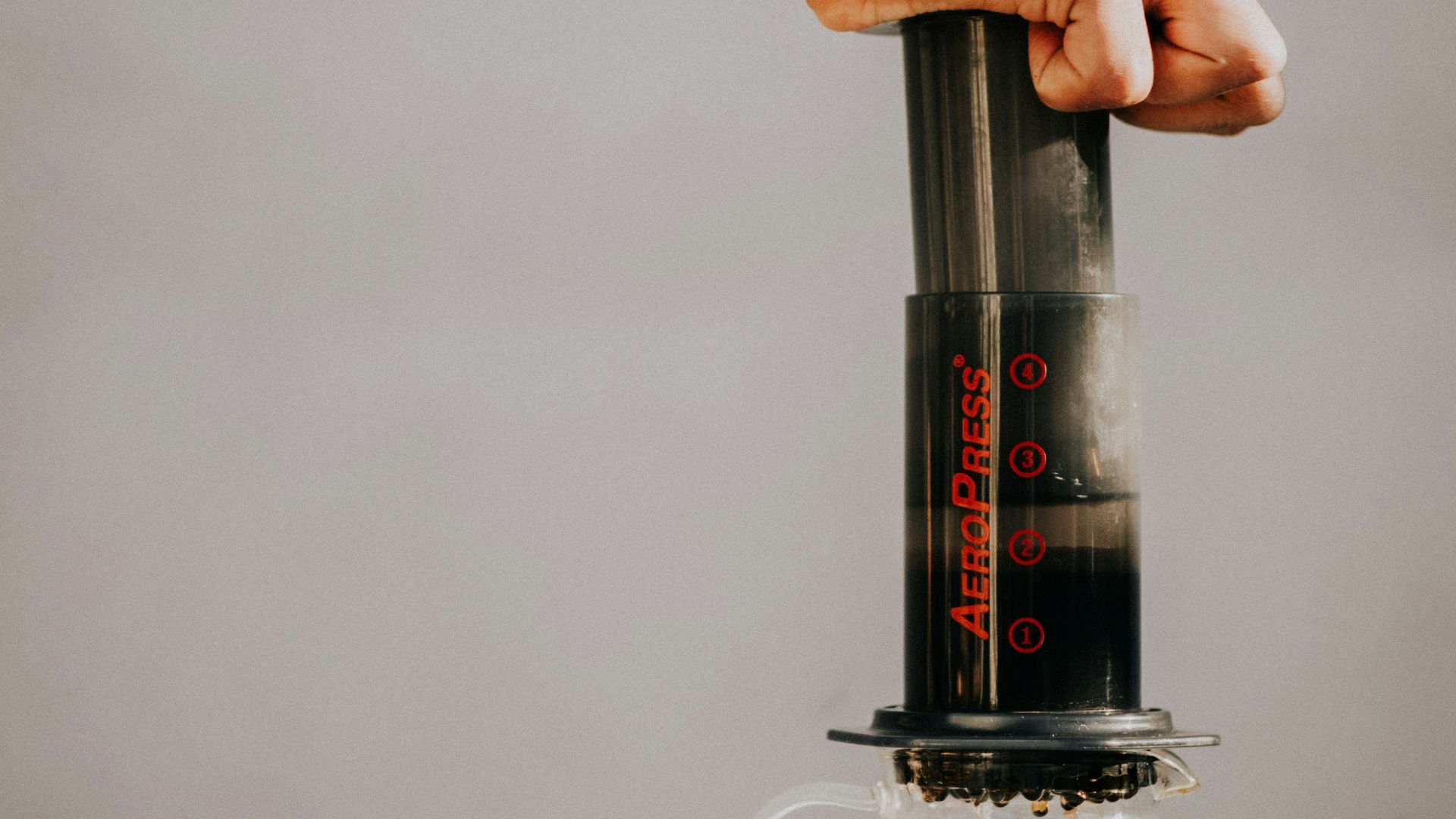 a hand holding a glass bottle