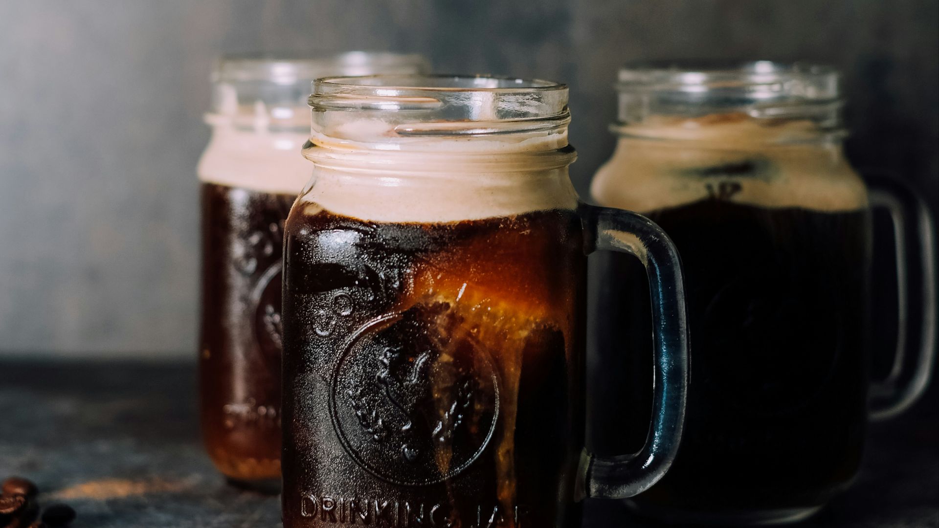 3 filled jar mugs by wall