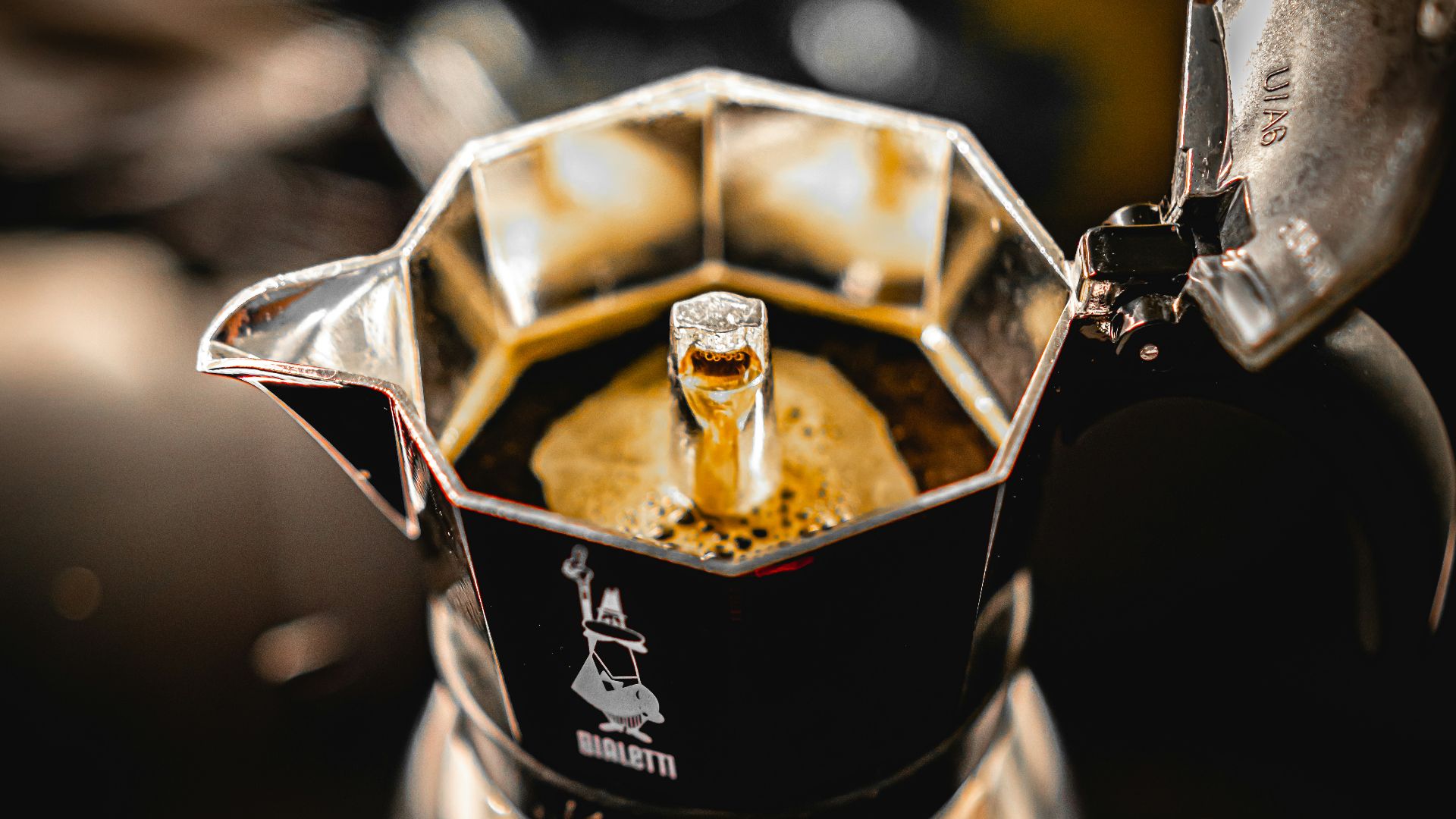 silver coffee pot pouring on clear glass cup