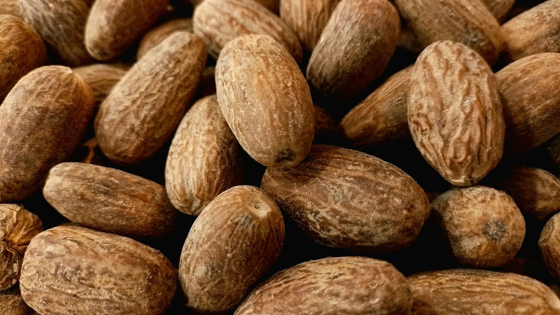 a pile of almonds sitting next to each other