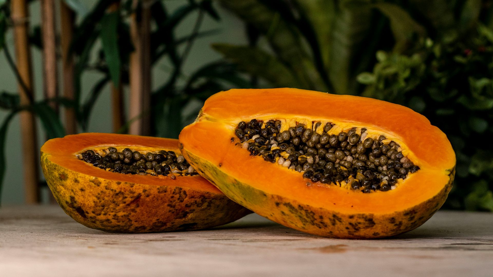 sliced papaya fruits on brown surface