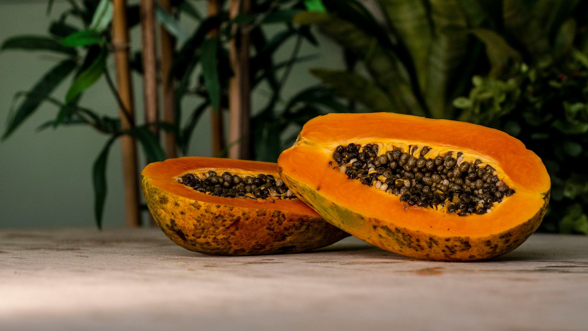sliced papaya fruits on brown surface
