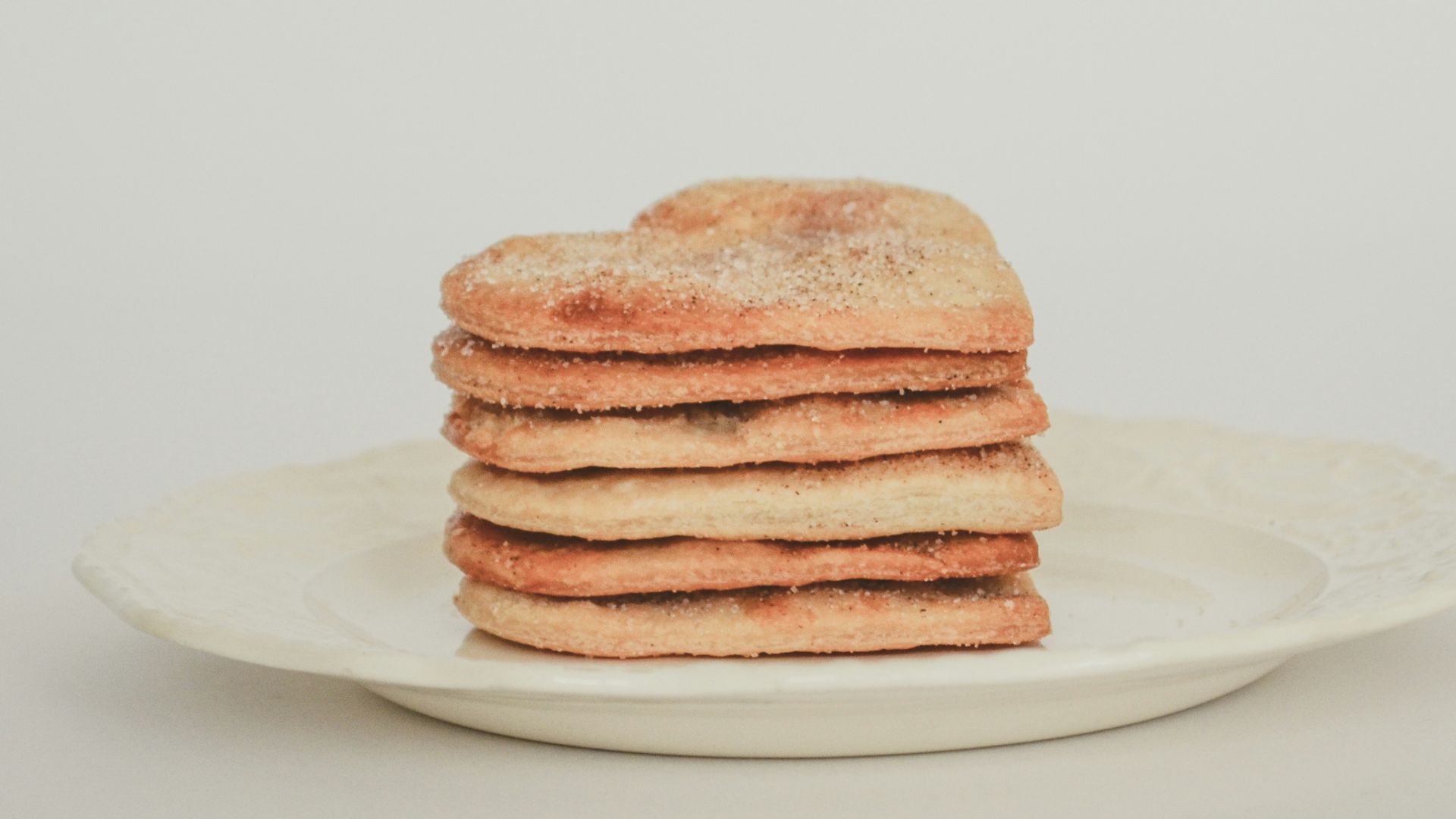 a stack of toasted bread on a white plate