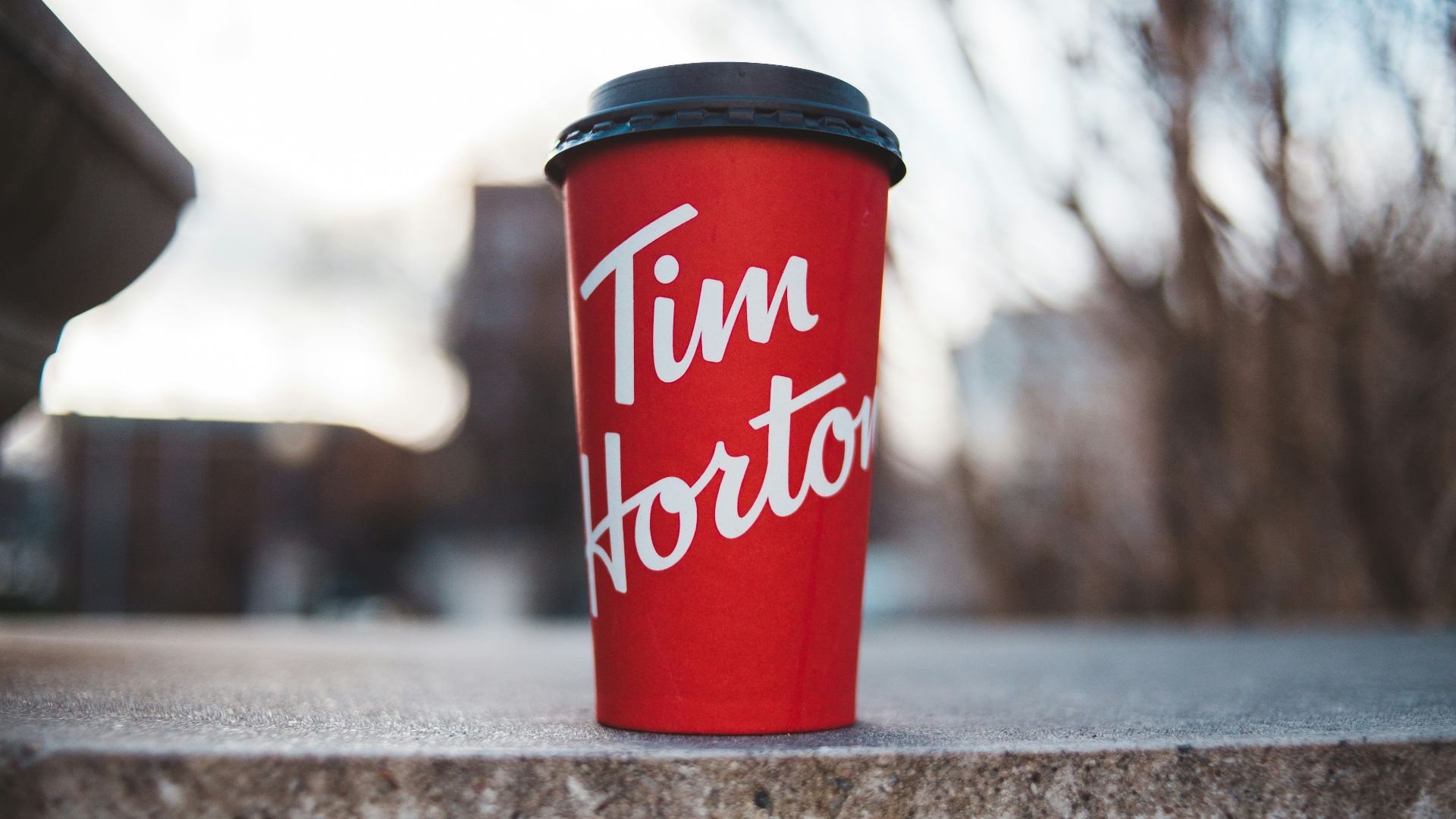 red and white plastic cup on gray concrete floor