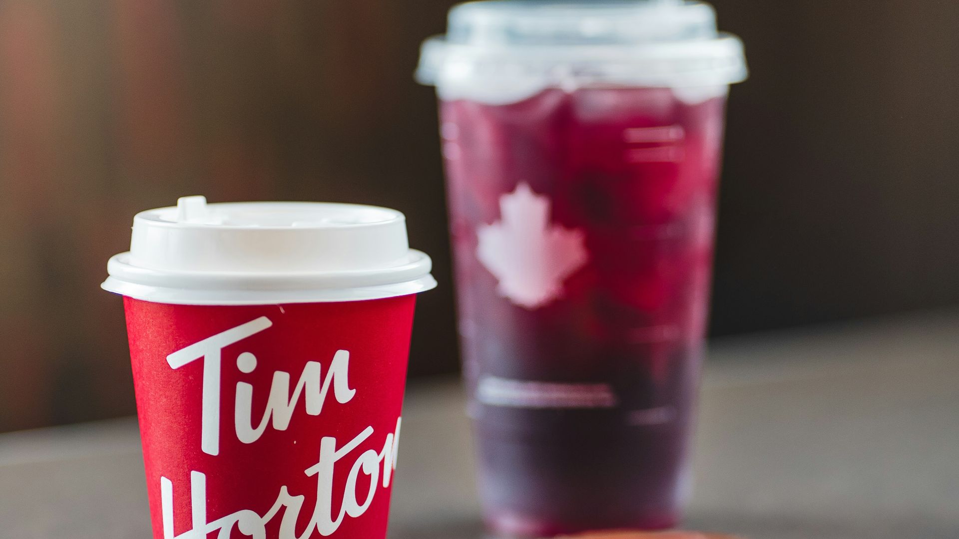 a cup of coffee and a doughnut on a table