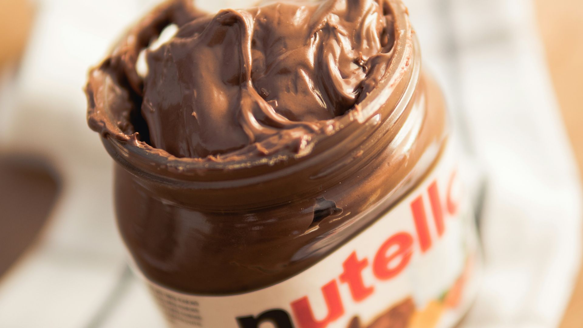 Nutella plastic container on white textile
