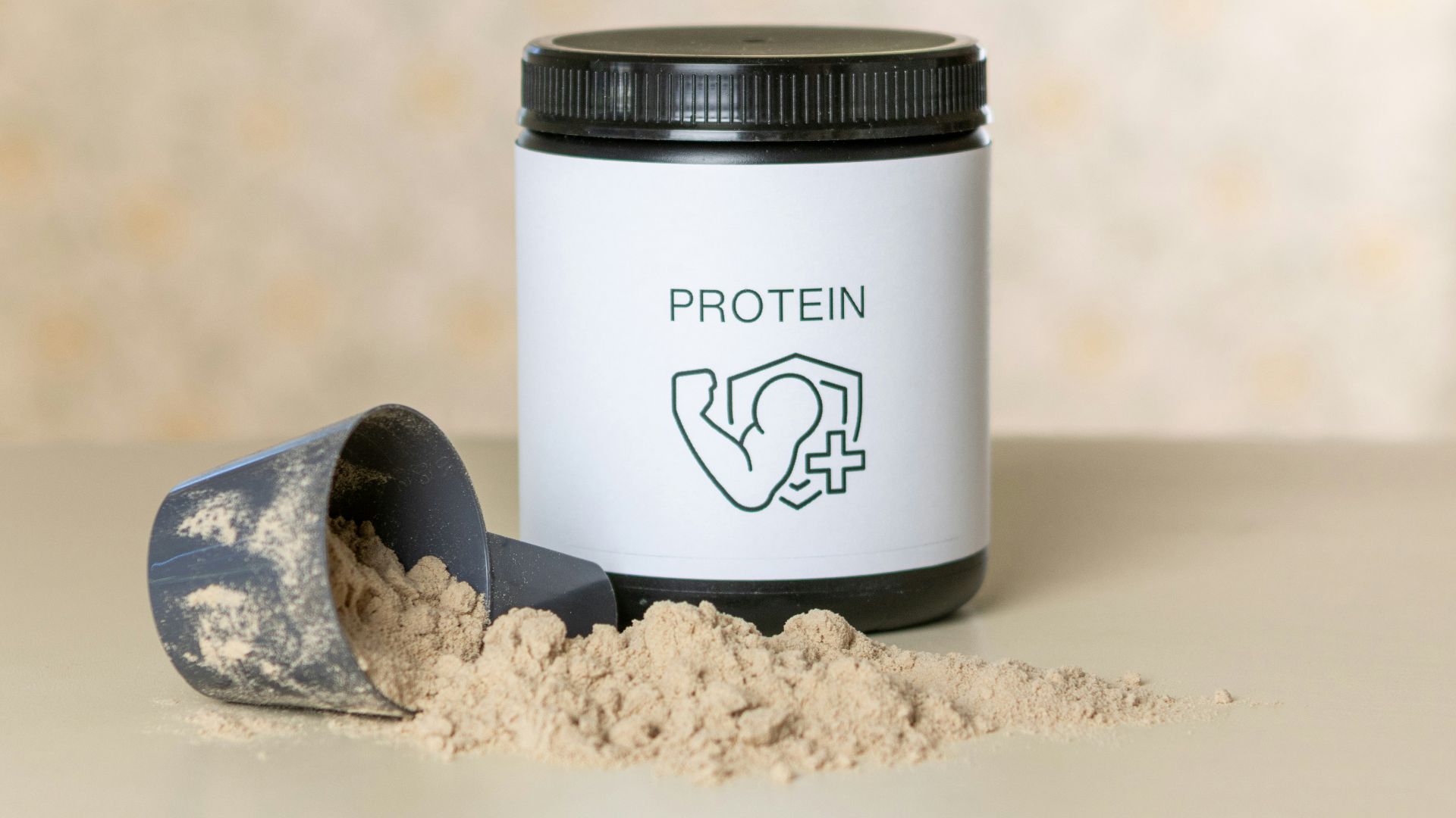 a jar of protein powder next to a scoop of powder