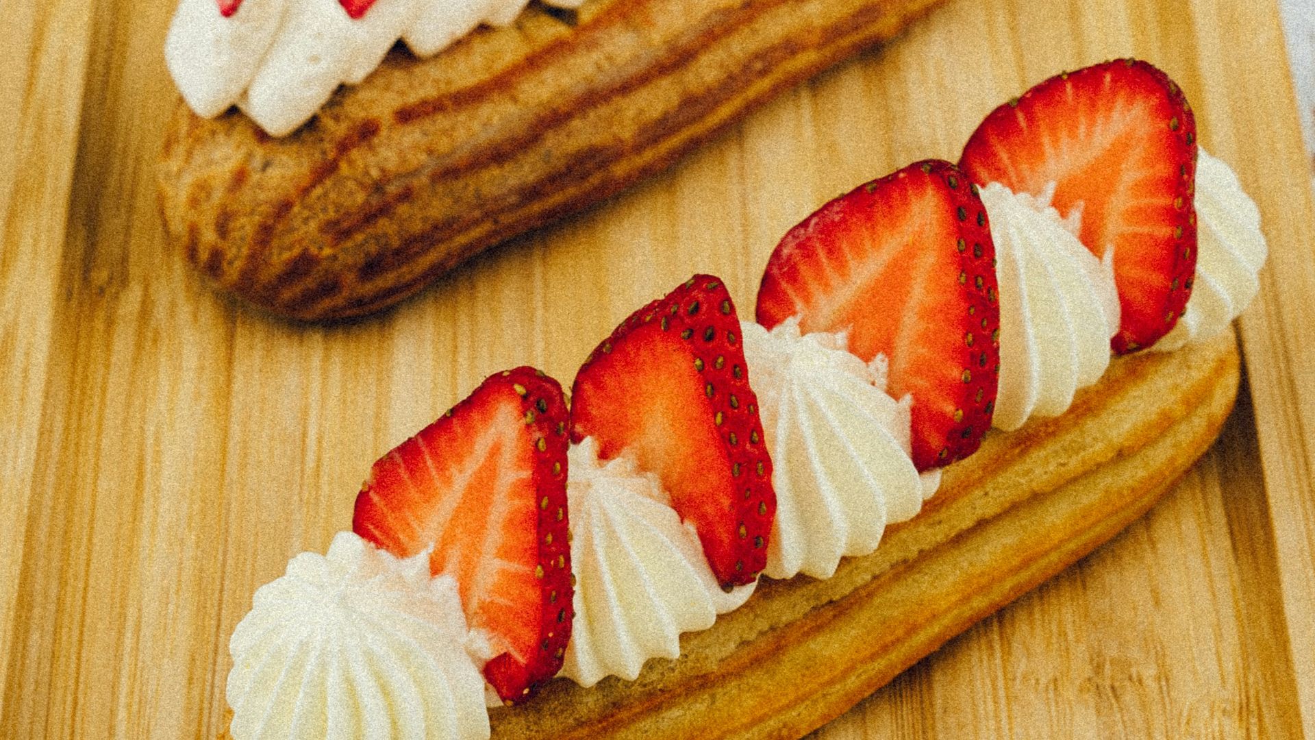 sliced strawberry and strawberry on brown wooden chopping board