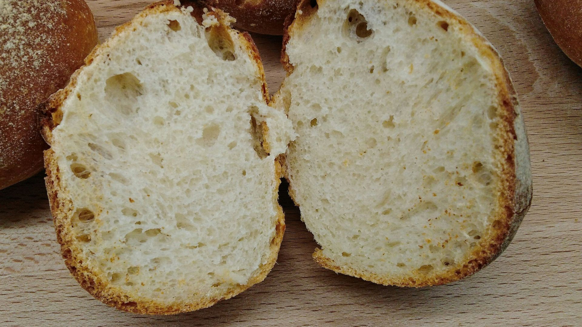 two brown bread on brown wooden table