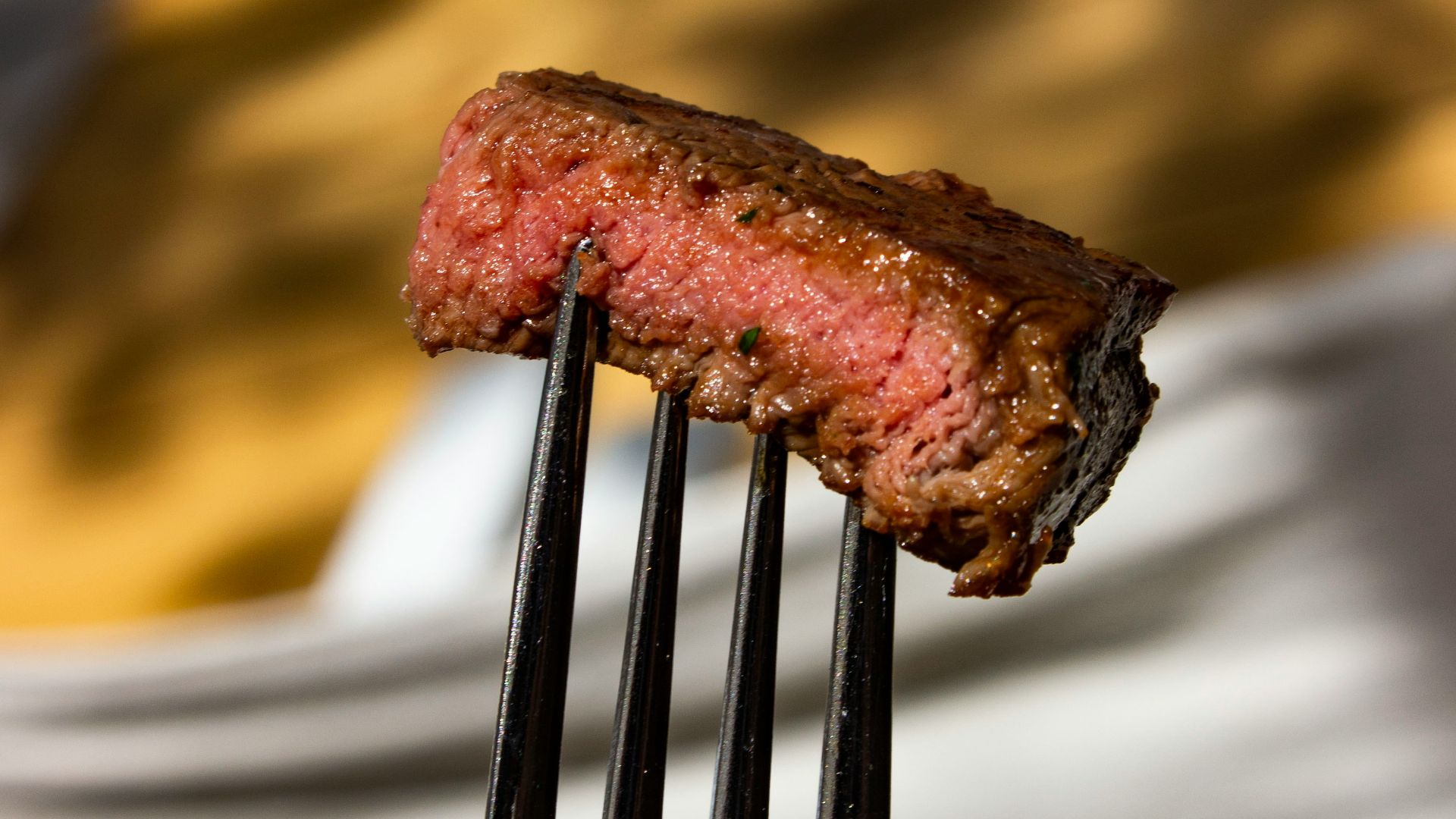 a fork with a piece of meat on it