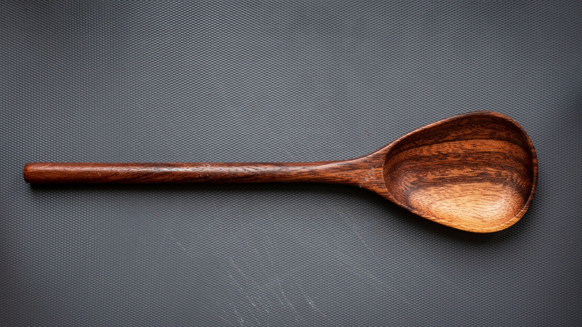 brown wooden spoon on white surface