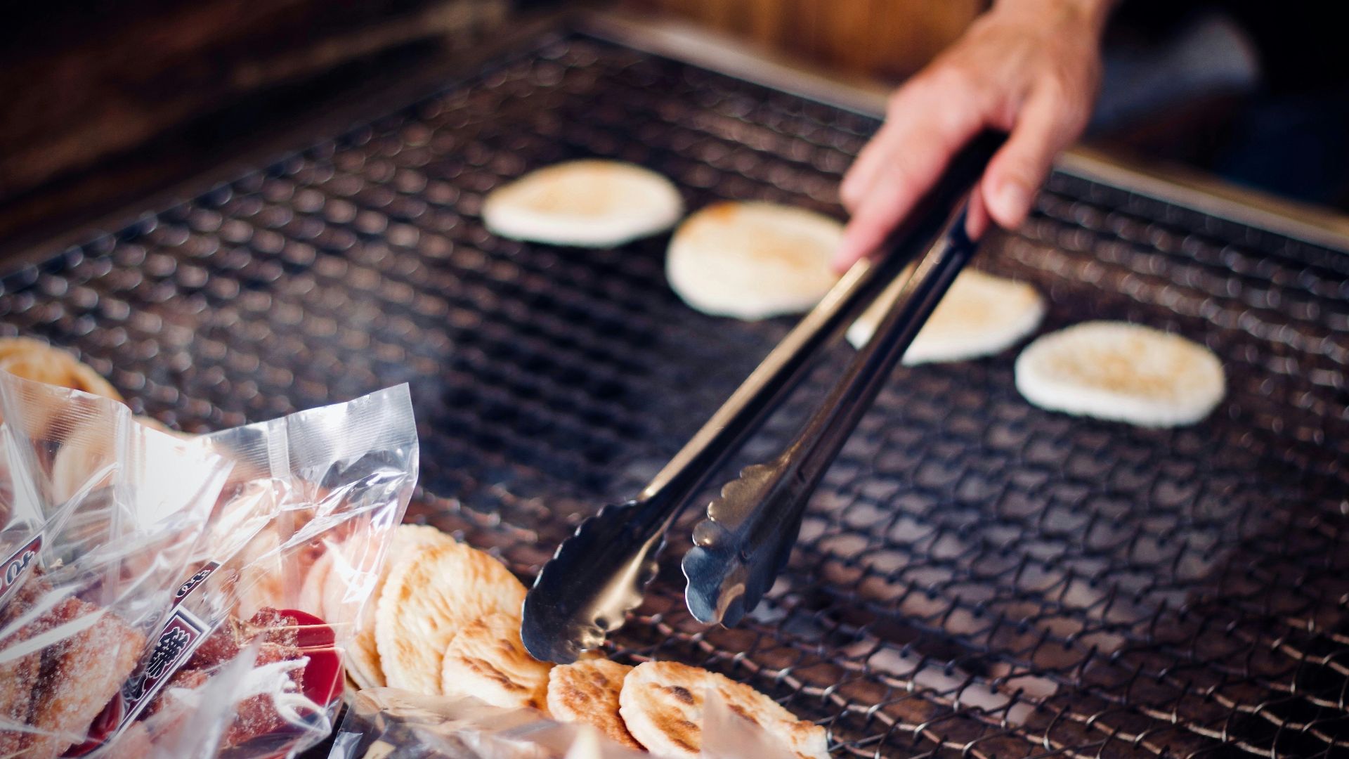 person holding tong while grilling