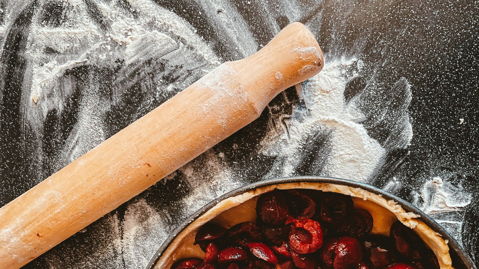 brown wooden rolling pin on stainless steel bowl