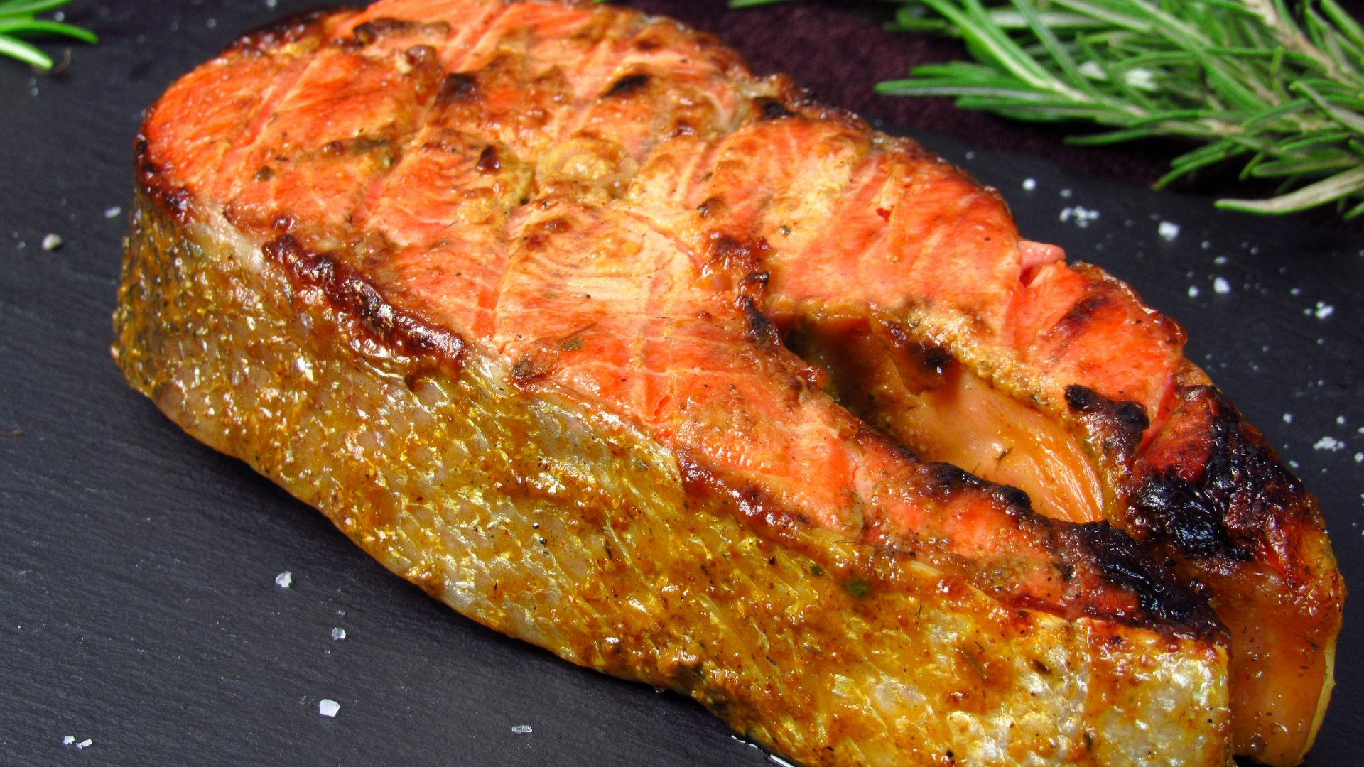 a piece of meat sitting on top of a black plate