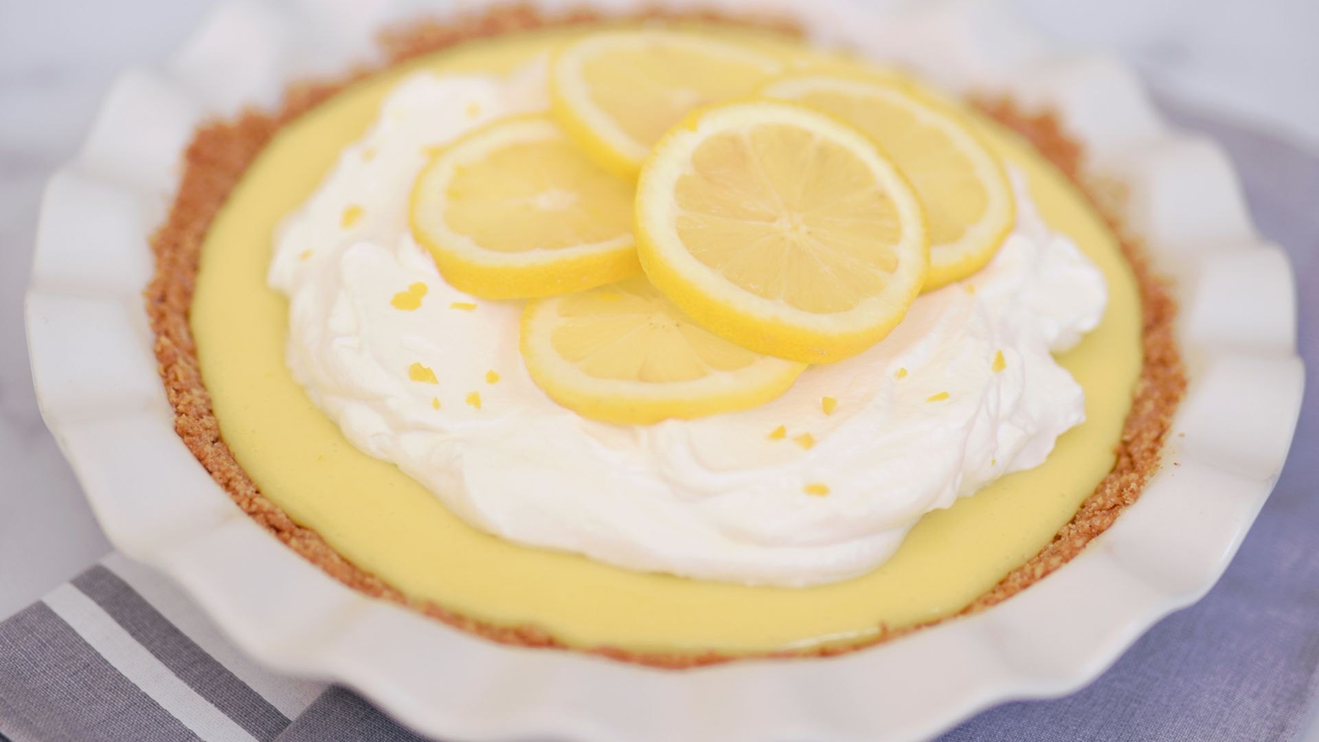 yellow and white cupcake on white and blue checkered textile