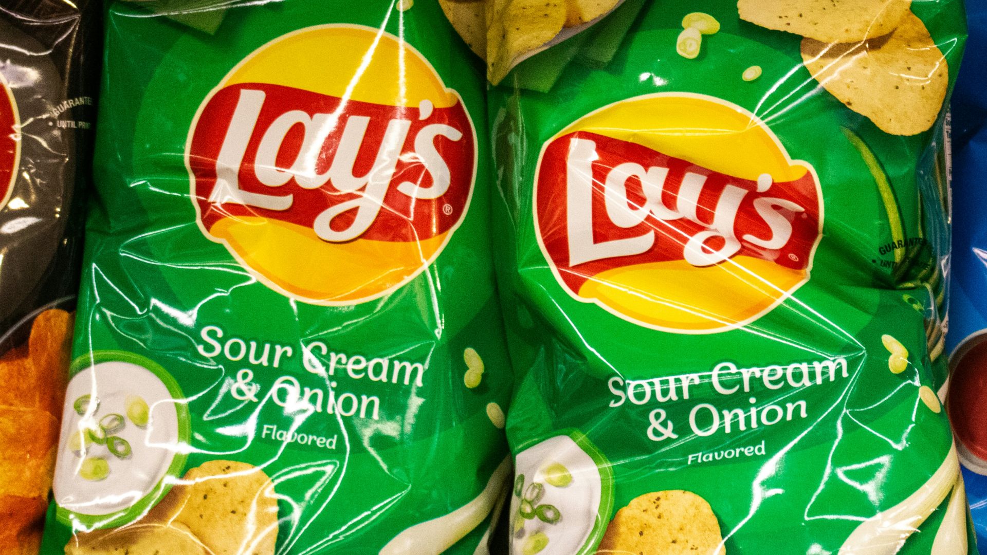 Several bags of lay's potato chips are displayed.