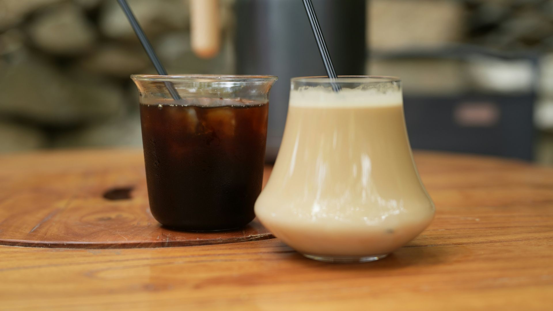 Iced coffee and a creamy drink on a table.