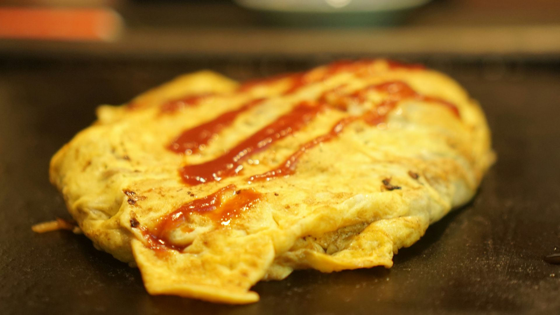 an omelet with ketchup on top of it