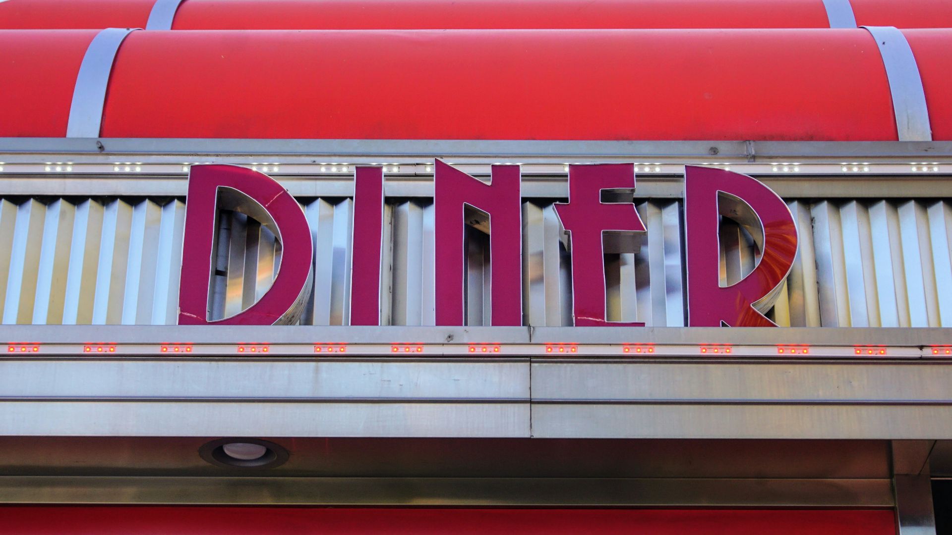 a sign that says diner on the side of a building