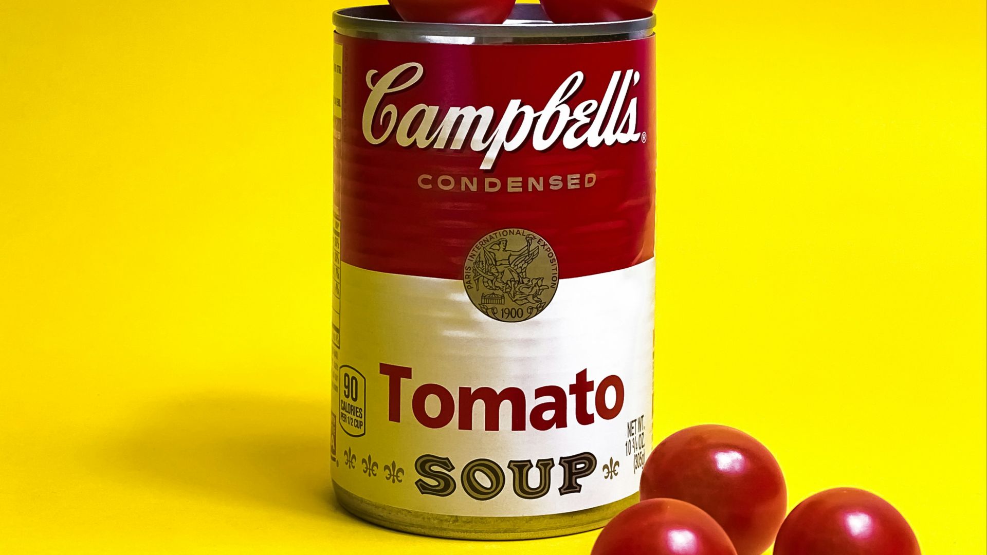 a can of tomato soup on a yellow background