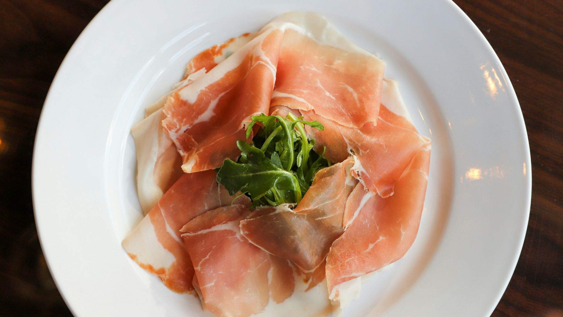 a white plate topped with meat and veggies