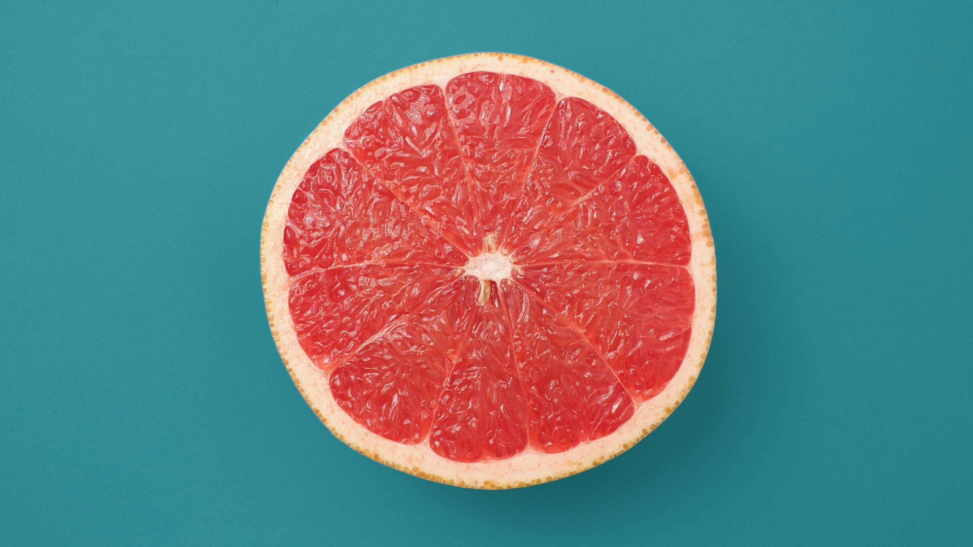 sliced orange fruit on blue background