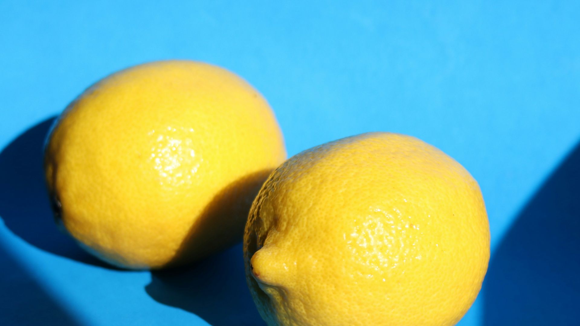 yellow lemon fruit on blue surface