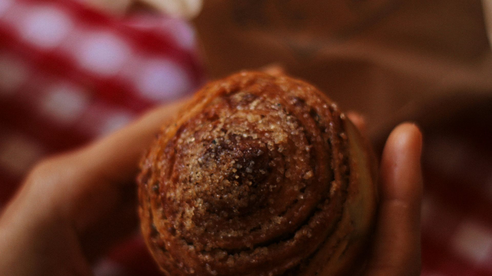 person holding brown round cookie