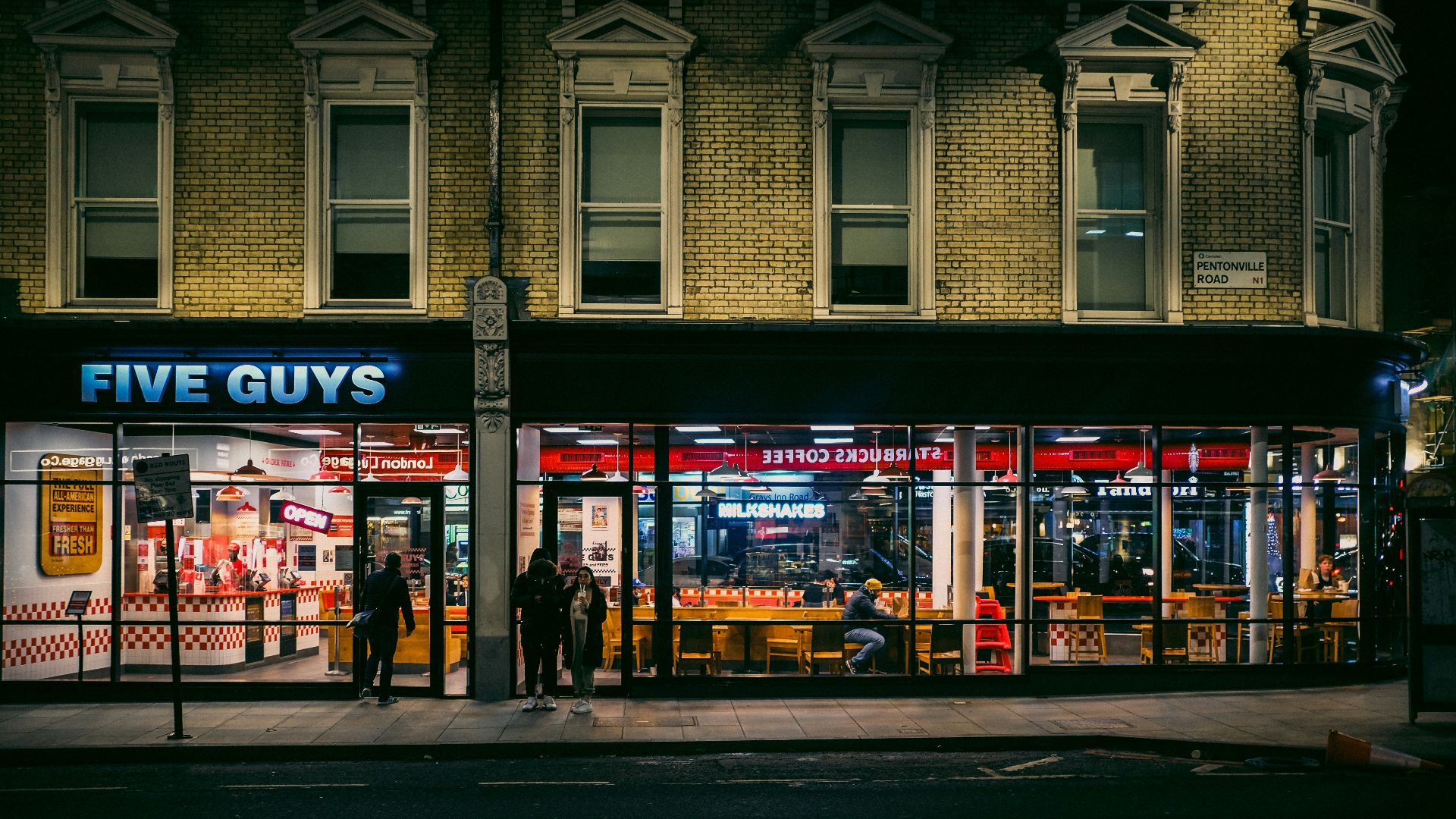 people walking on sidewalk near store during daytime