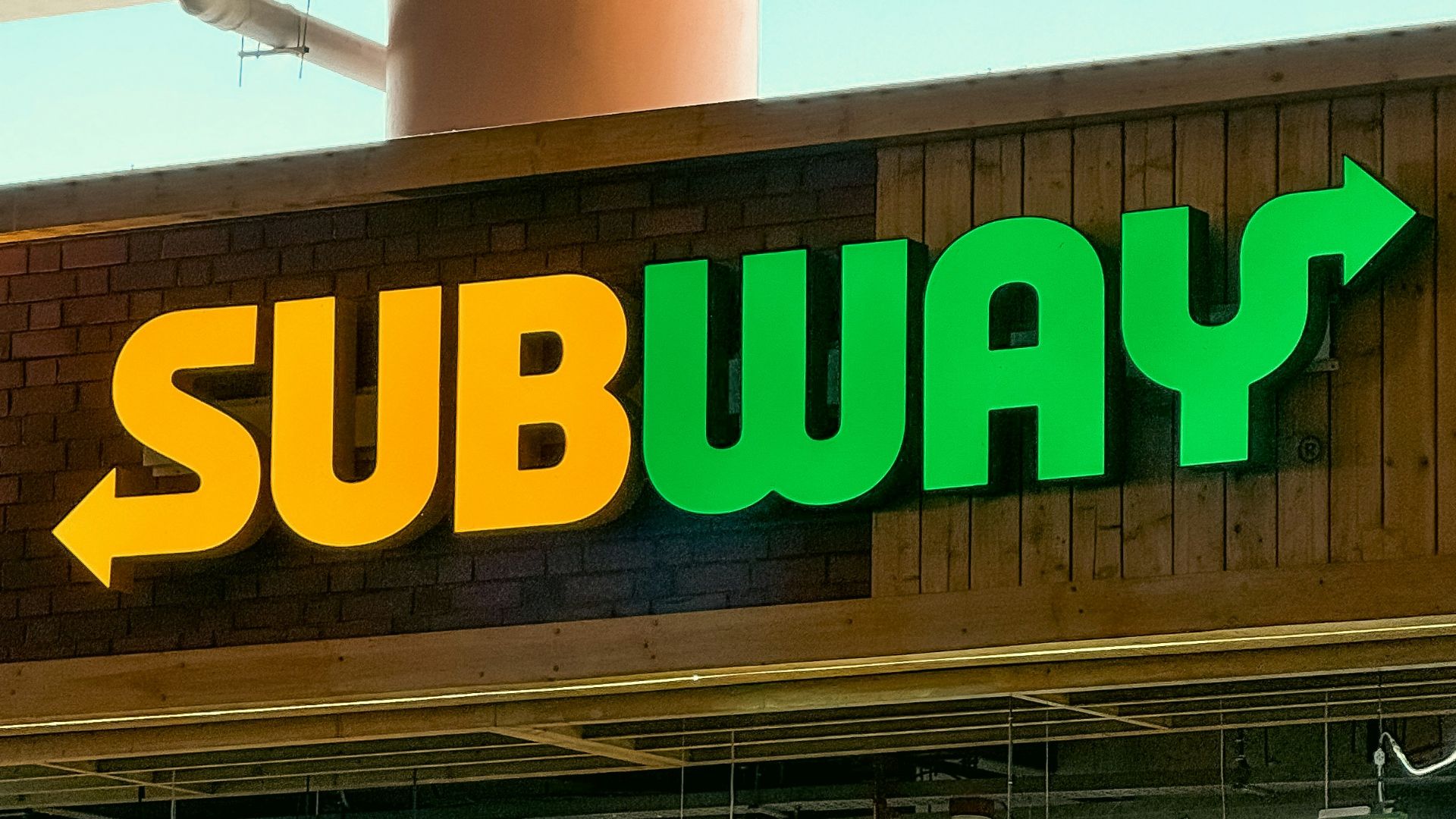 a subway sign above a subway entrance