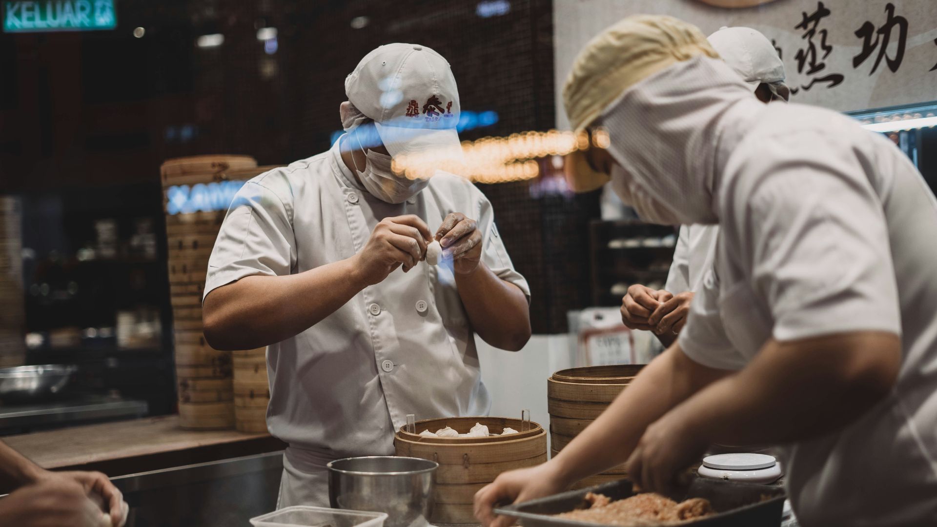 two man wrapping food