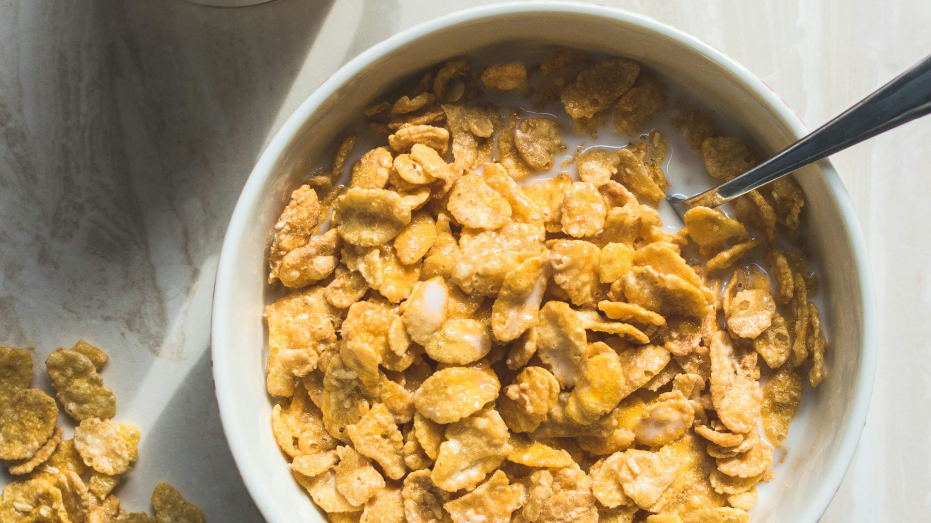 ceramic bowl filled with cereals and spoon